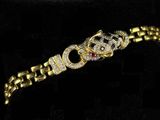 a close up of a gold bracelet with diamonds on it