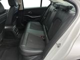 the back seats of a white car with black trims