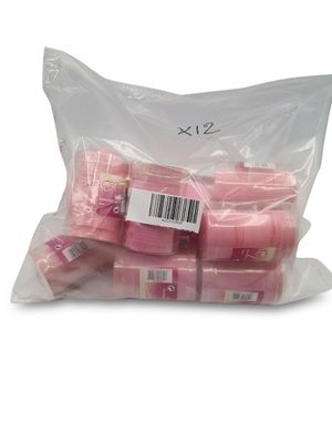a bag of pink soaps sitting on top of a white table