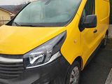 a yellow van that is parked in a parking lot