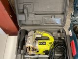 a tool box with a drill and a corded cord in it