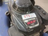 a blue lawn mower that is sitting on the ground