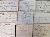 several pieces of old paper with writing on them sitting on a table