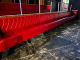 a red bench in the middle of a room
