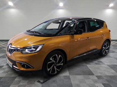 a yellow car is parked in a room with a checkered floor