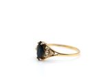 a gold ring with a blue sapphire stone and diamonds