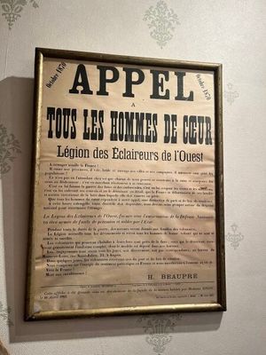 a framed poster on the wall of a room