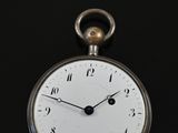 a close up of a pocket watch on a black surface