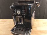 the coffee machine is sitting on the table ready to be used