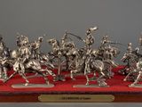 silver figurines of a group of men on horses with spears