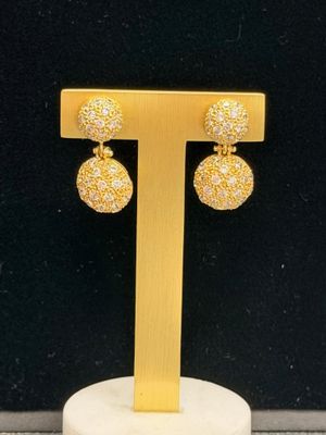 a close up of a pair of earrings on a stand
