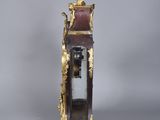 a clock that has a statue on top of it
