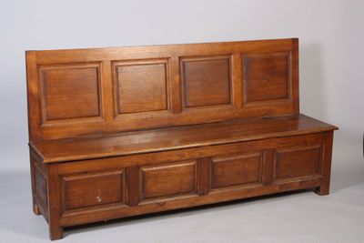 a wooden bench that is sitting next to a chair