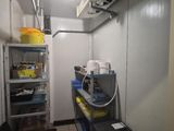 an image of a room with a lot of items on the shelves