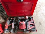 a red tool box with tools in it on the floor