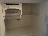 an open refrigerator with a blue light inside of it