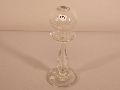 a clear glass candle holder on a white table