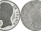 an old silver coin with a woman ' s profile on it