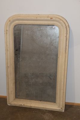 a mirror that is sitting on the floor in a room