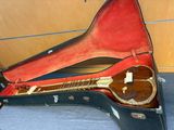 a guitar in a case sitting on the floor