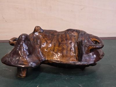 a statue of a cow that is sitting on a table