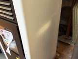 a refrigerator that is sitting on a pallet in a room