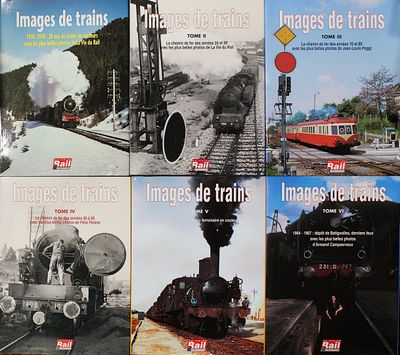 quatre livres posés sur une table, avec des images de trains sur la couverture