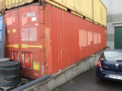 a car that is parked in front of a large container