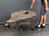 a man that is standing next to a wooden boat