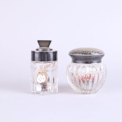 two salt and pepper shakers sitting next to each other