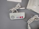 a white electronic device and a charger sitting on a table