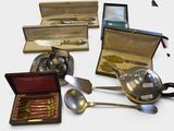 many different types of silverware and spoons on the table