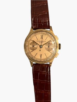 une image d'une montre-bracelet en or avec un bracelet en cuir marron