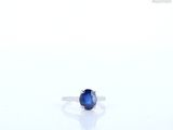 an image of a sapphire ring on a white surface