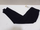the leggings of a pair of black pants are on a white surface