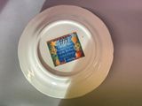 a white plate with a sticker on it on a table
