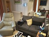 a living room with a couch, chair, coffee table and television
