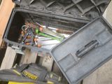 a tool box with tools in it sitting on the floor