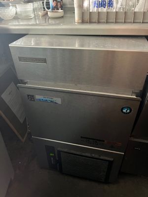 a silver refrigerator and a silver counter top in a kitchen