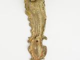 brass sconce on a white wall with a bird on it