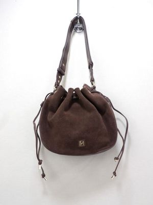 the small brown bag is hanging on a hook on the wall
