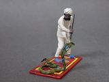 a figurine of a man with a snake on a rug