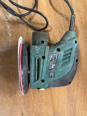 a sander on a table with a cord attached to it
