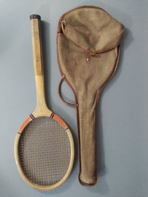 a tennis racket and a bag hanging on the wall