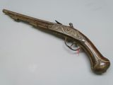a close up of a gun on a table with a white background