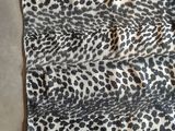 a close up of a leopard print scarf on a table