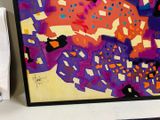 a picture of a painting on a desk next to a keyboard