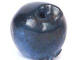 a blue vase that is sitting on a white surface
