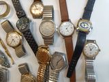 a lot of watches that are sitting on a table