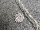 a close up of a piece of clothing with a coin on it